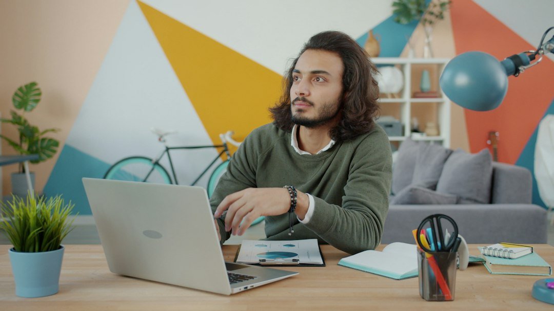 Man using a laptop thoughtfully for online support